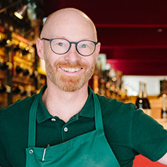 Liquor store owner smiling