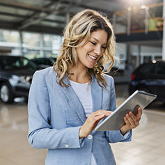 Smiling lady with ipad and insurance