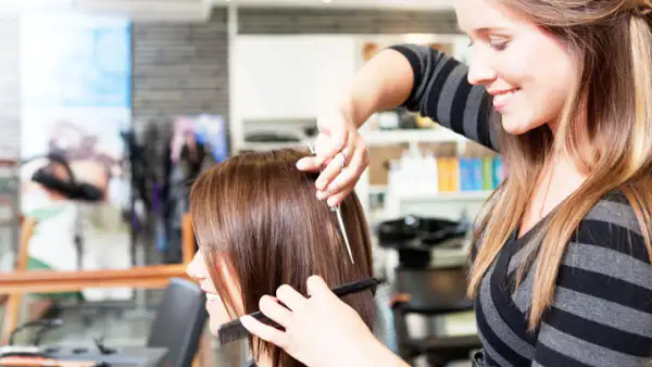 Haircutting lady lovingly cutting hair in a beautiful award winning studio